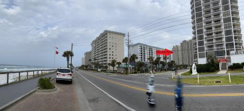 a car driving down a street next to the ocean at Ariel Dunes II 204 - Miramar Beach in Destin