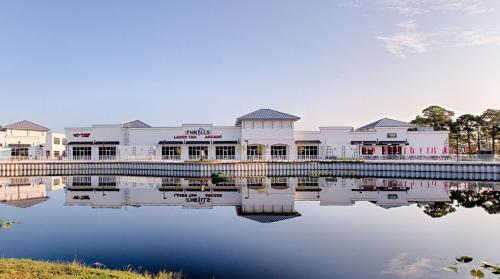 a building next to a body of water at Ariel Dunes II 204 - Miramar Beach in Destin