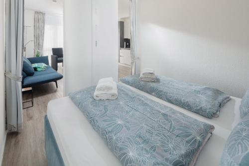 a bedroom with two beds with towels on them at Luisenstudio in Norderney