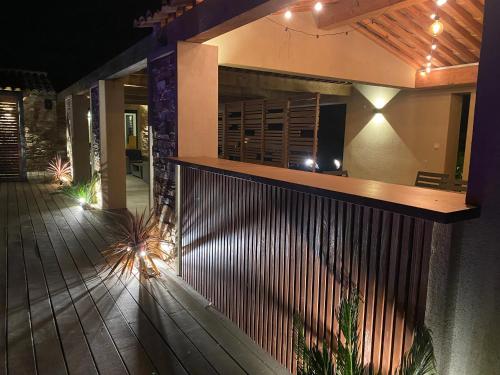 a house with a wooden fence in front of it at Magnifique villa avec piscine au coeur des vignes in Cogolin