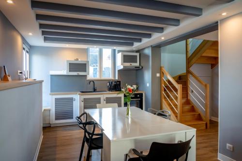 a kitchen with a white table and chairs at Appartement Acadie in Le Palais