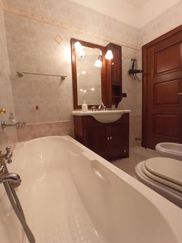 a bathroom with a tub and a sink and a toilet at Meraviglie Salentine in Lequile