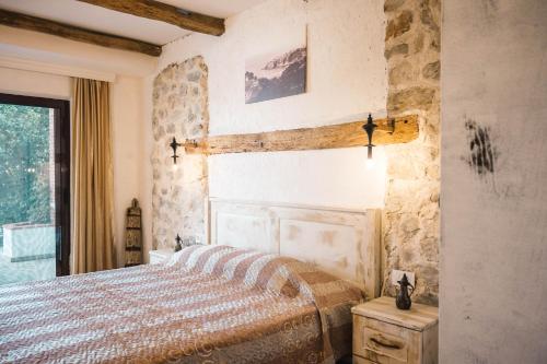 a bedroom with a bed and a large window at Apartments Bazar in Ulcinj