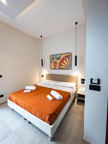 a bedroom with a bed with two towels on it at MARINO WELLNESS in Ali Terme