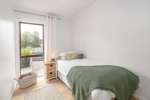 Ένα ή περισσότερα κρεβάτια σε δωμάτιο στο Tui Cottage