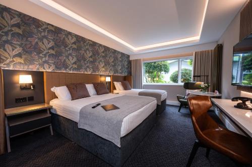 a hotel room with a bed and a desk at Hotel Kilkenny in Kilkenny