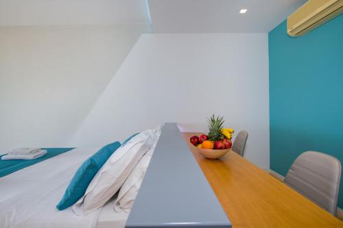 a table in a room with a bowl of fruit on it at Balos Beach in Kissamos