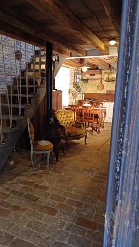 a living room with chairs and stairs and a table at Dimora 421 ApartSuite Chioggia in Chioggia