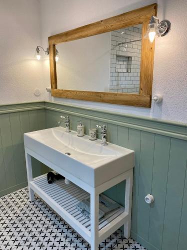 a bathroom with a white sink and a mirror at Chata Paradise in Smižany