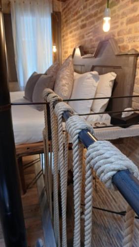 a room with a bed and a table with ropes at Dimora 421 ApartSuite Chioggia in Chioggia