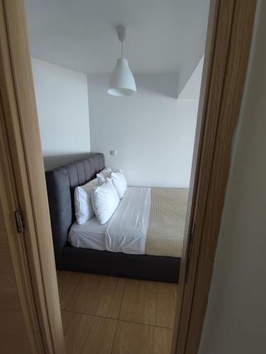 a bedroom with a bed with white sheets and pillows at La Casa Azul in Arkoudi
