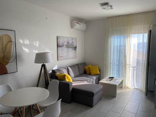 a living room with a couch and a table at Infinity Panorama Apartment in Tivat