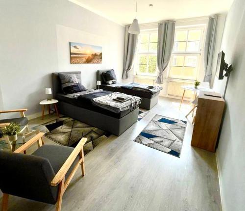 a living room with two beds and a couch at City Apartments Erfurt in Erfurt
