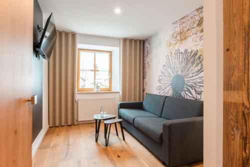 a living room with a couch and a table at Gasthof Krone in Kinding