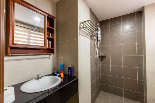a bathroom with a sink and a shower at HyperTribe -Pangkor Holiday Home in Kampong Sungai Udang