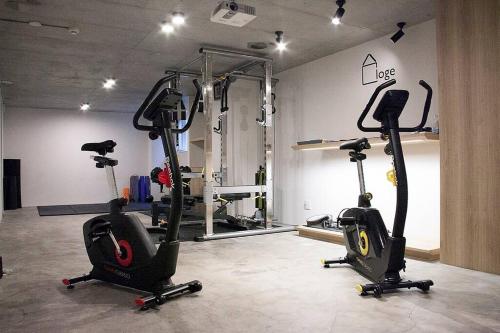 a gym with three exercise bikes in a room at Stay Well & Give Well, Full Building in Asakusa in Tokyo