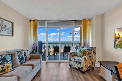 a living room with a couch and a chair at Beachfront Condo in Atlantica Resort with Pool in Myrtle Beach