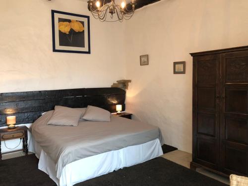 a bedroom with a bed with two lamps and a dresser at Château de Laumière in Promilhanes
