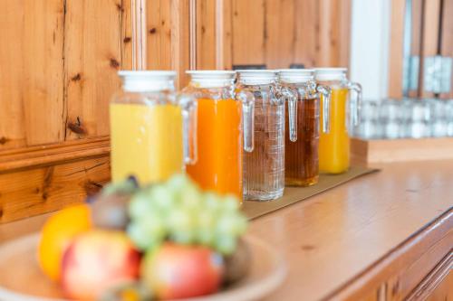 a counter with jars of juice and a plate of fruit at Gasthof Krone in Kinding