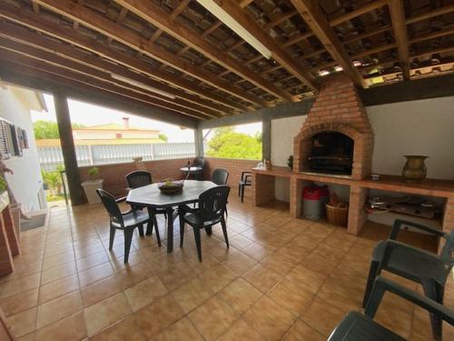 a living room with a table and a fireplace at Casa Gorjão in Anadia