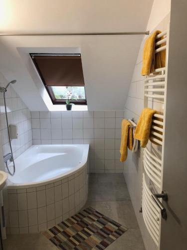 a bathroom with a bath tub and a window at Svájci Lak Panzió in Nyíregyháza