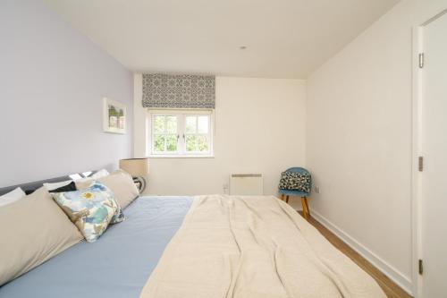 a bedroom with a large bed and a window at Central but quiet in Oxford