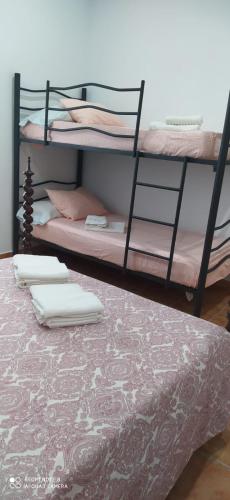 two bunk beds in a room with a bed at Lo raconet in L'Ampolla