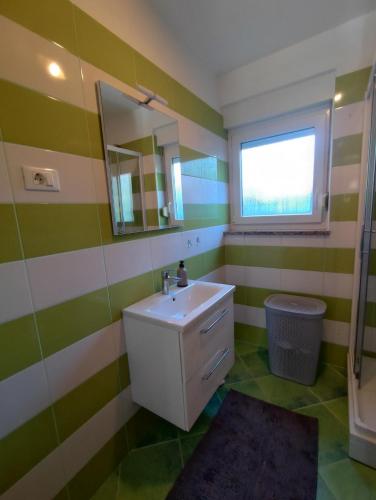 a bathroom with a sink and a mirror at Villa Maya - Family in Ližnjan