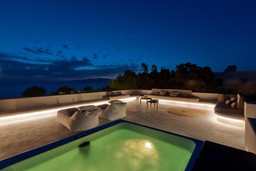 a swimming pool on the roof of a house at night at Beachfront 3BR Villa Iremia in Naxos in Naxos Chora