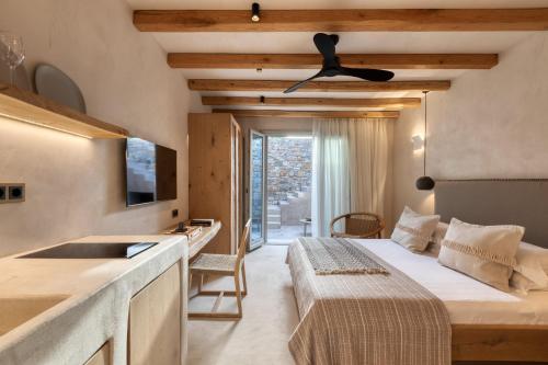 a hotel room with a bed and a sink and a television at Beachfront 3BR Villa Iremia in Naxos in Naxos Chora