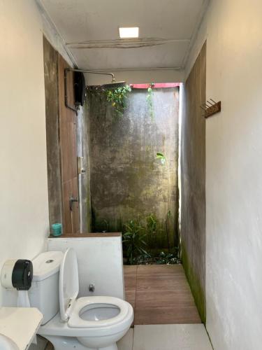 a bathroom with a toilet in a room at Sailor's Rest in Kampung Janda Baik