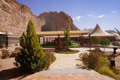 a building with a mountain in the background at Hasan Zawaideh Camp in Wadi Rum