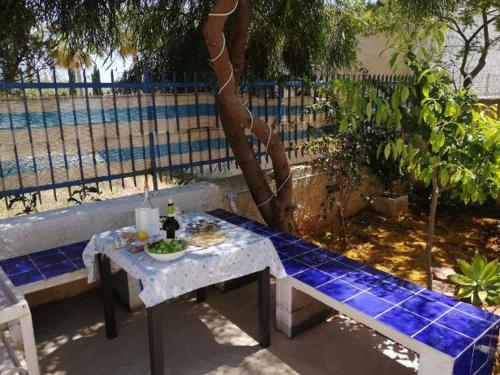 a picnic table with a plate of food on it at Villa Sunshine in Triscina