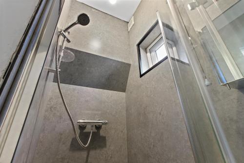 a shower in a bathroom with a window at Maidstone Best 1 Bed City Centre Flat - Fast Wi-Fi in Maidstone