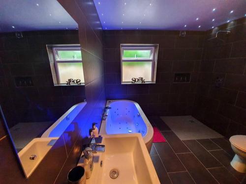 a large bathroom with a tub and a sink at Entire Family Home By The Sea in Scarborough