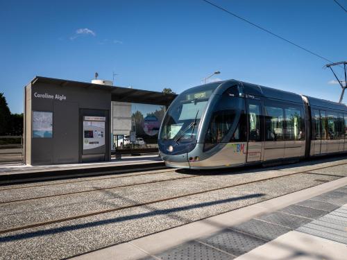 a train on the tracks at a train station at ibis Styles Bordeaux Aéroport in Mérignac