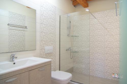 a bathroom with a shower and a toilet and a sink at Villa Theodora View Apartments Erato in Agios Georgios Pagon