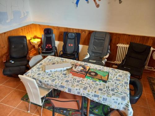 a table and chairs in a room with a table and chairsktop at Triniti Vendégház in Eger
