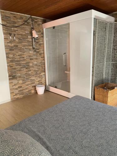 a bedroom with a bed and a brick wall at B&B Villa degli Angeli in Bernalda