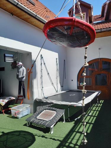 a man is standing next to a trampoline at Triniti Vendégház in Eger