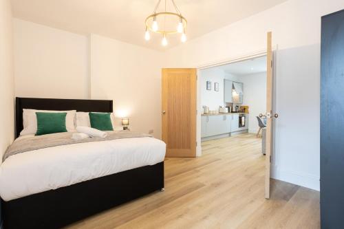 a bedroom with a large bed and a hallway at Apartment 4 - Beautiful 1 Bedroom Apartment Near Manchester in Worsley
