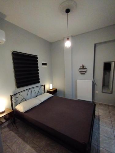 a bedroom with a large bed with a black headboard at Mirina center apartments in Myrina