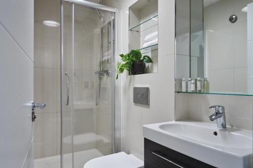 a bathroom with a shower and a sink and a toilet at Wembley Stadium by Viridian Apartments in London