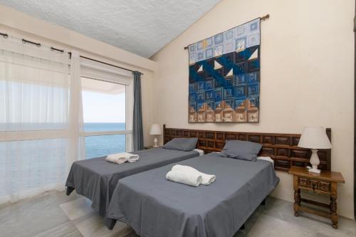 a bedroom with two beds with towels on them at Bahia Dorada 4 in Estepona