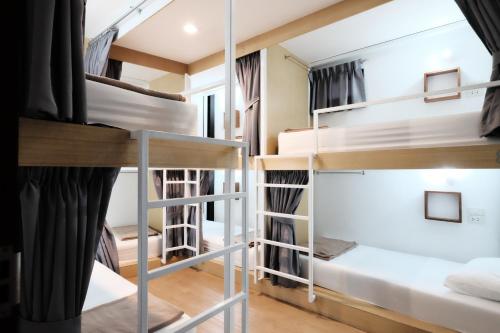 a group of bunk beds in a dorm room at Wayha Hostel Don Mueang Airport in Bangkok