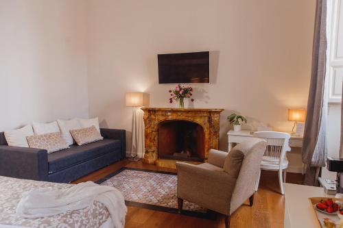 a living room with a couch and a fireplace at My Spanishsteps in Rome