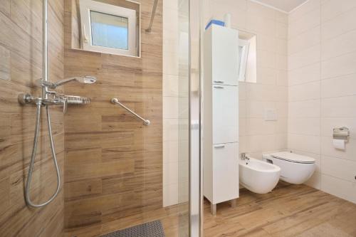 a bathroom with a toilet and a shower stall at App Forza in Umag
