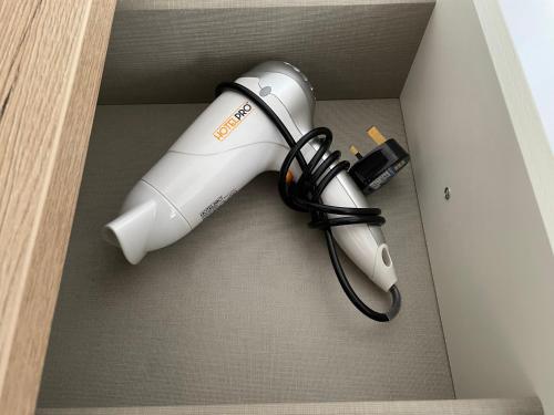 a blow dryer in a box with a cord at The Sandrock in Clacton-on-Sea