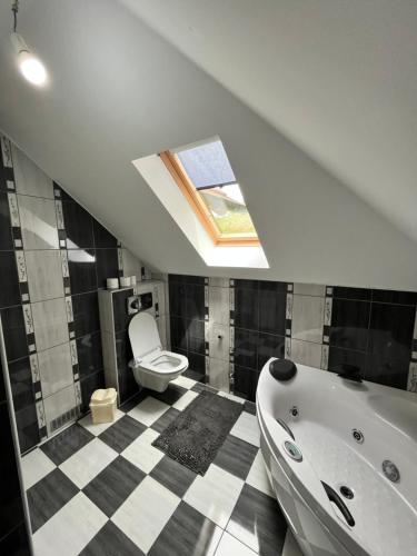 a bathroom with a toilet and a bath tub at Cobras Plivsko jezero, Jajce in Jajce