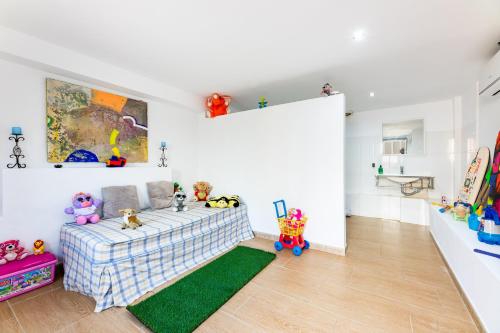 a living room with a couch and a green rug at Bahamas 2 in Son Serra de Marina